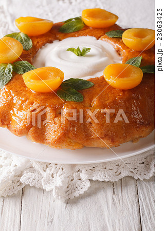 French Savarin cake decorated with apricots French Savarin cake decorated with apricots 23063425
