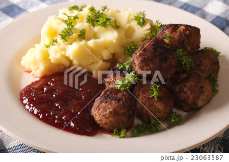 fried meatballs, lingonberry sauce with potato 23063587