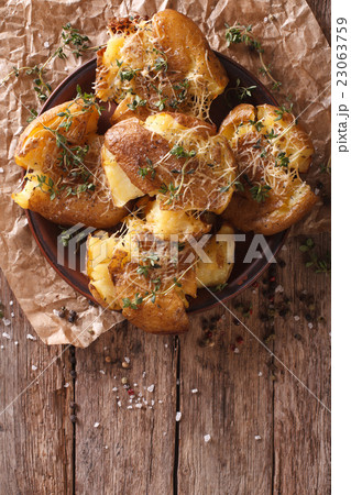 crash hot potatoes with thyme on a plate close-up 23063759