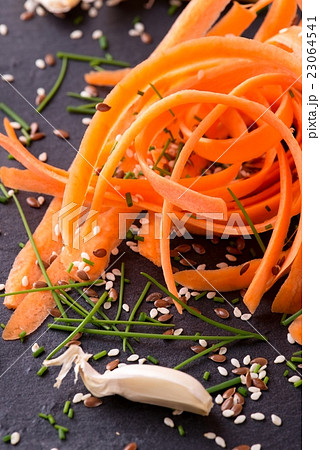 Heap of carrot shavings with pieces of chive Heap of carrot shavings with pieces of chive 23064541