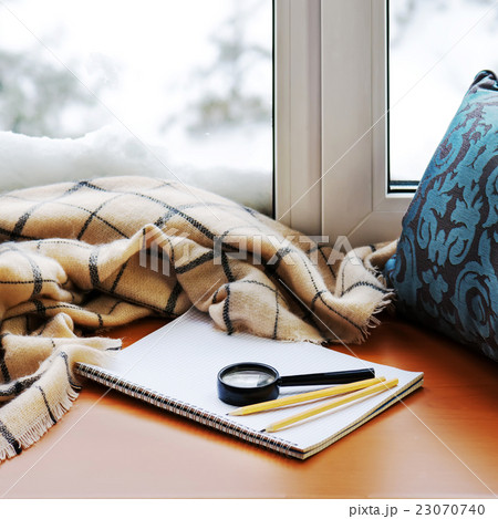 Open notepad, magnifier glass, pillow, pencils Open notepad, magnifier glass, pillow, pencils 23070740