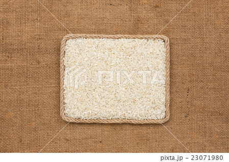 Frame made of rope with rice grains on sackcloth Frame made of rope with rice grains on sackcloth 23071980