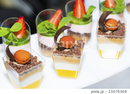 mini canapes in plastic cups decorated with edible 23076369
