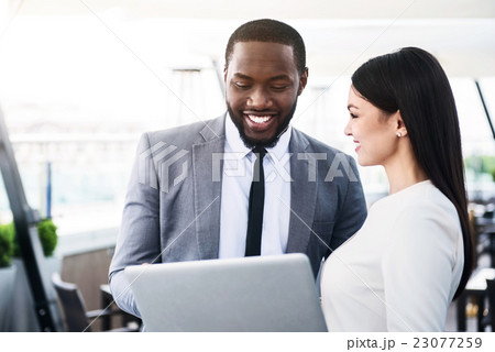 Cheerful colleagues talking 23077259