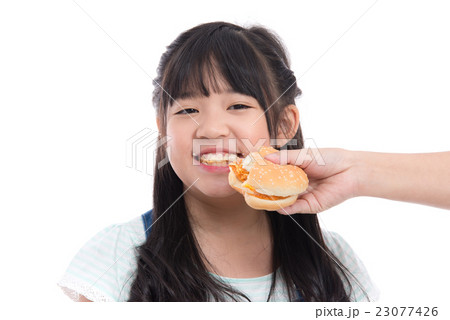Beautiful asian girl eating hamburger 23077426