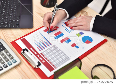 businesswoman checks start up report businesswoman checks start up report 23077675