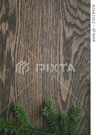 fir branch on stained oak table from above fir branch on stained oak table from above 23078428