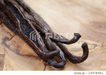 open vanilla pod on olive board 23078461