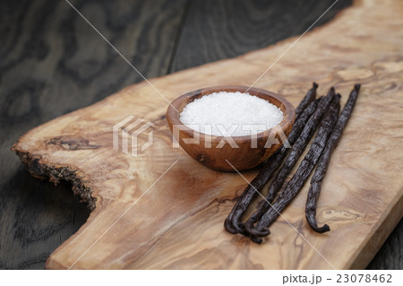 bourbon vanilla pods with white sugar on table 23078462