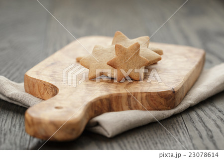 homemade star shape ginger cookies on olive board 23078614