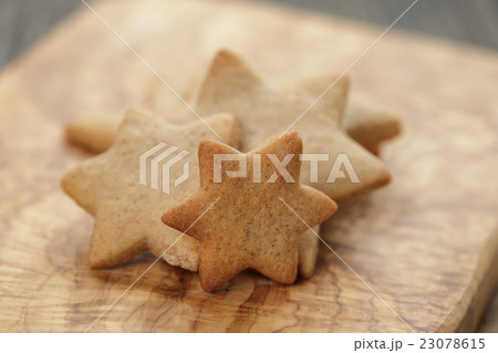 homemade star shape ginger cookies on olive board 23078615