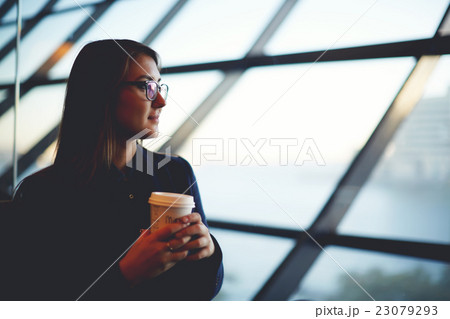 Charming girl sitting in the airport with coffee  23079293