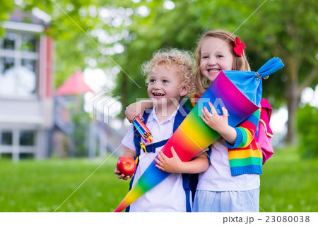Kids with candy cone on first school day. 23080038
