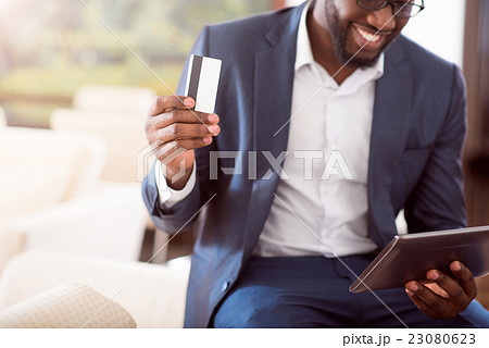 Successful man holding bank card 23080623