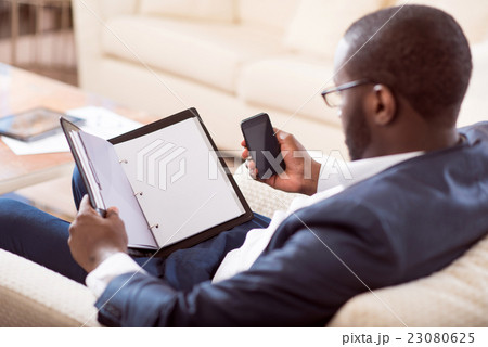 Afro American man holding a folder 23080625