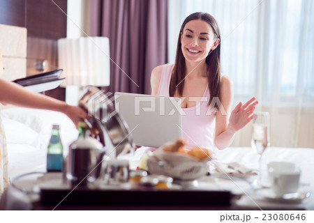 Woman looking at her order in hotel Woman looking at her order in hotel 23080646
