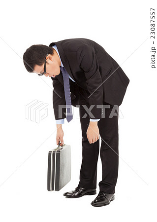 tired young businessman rubbing his eyes  23087557