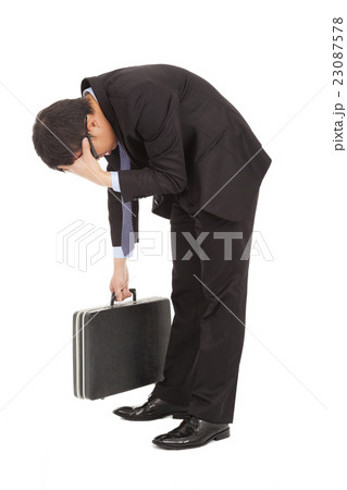 afflictive businessman stoop and hold his head afflictive businessman stoop and hold his head 23087578
