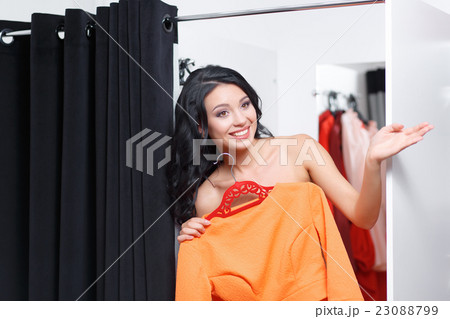 The young woman is dressed in a fitting shop 23088799