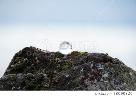glass ball on mossy rock in Thai beautiful beach 23090320