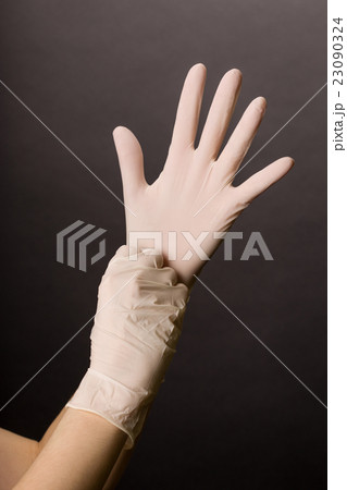 Putting on latex gloves 23090324