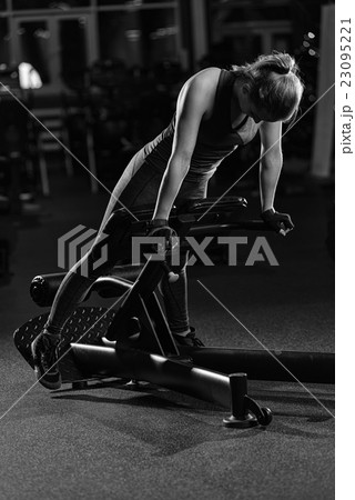 Woman doing strength exercises for abs muscles 23095221