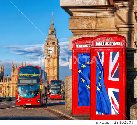 Big Ben with flags against buses in London, UK 23102609