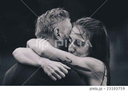 beautiful couple hugging in the rain 23103759