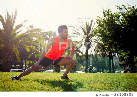 Man warming up before begin his run Man warming up before begin his run 23108309