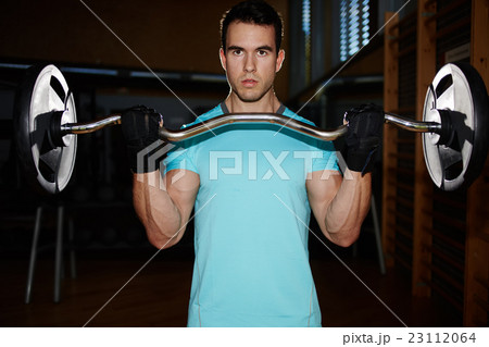 Man doing heavy dumbbell exercise for biceps Man doing heavy dumbbell exercise for biceps 23112064