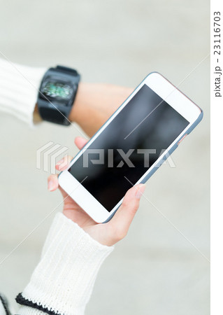 Woman use of smartwatch and cellphone 23116703