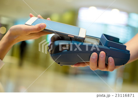 Customer using cellphone for payment Customer using cellphone for payment 23116871
