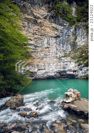 small mountain lake with green surface at the rock small mountain lake with green surface at the rock 23124022