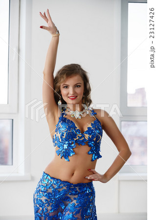 Belly dancer in costume embroidered with sequins 23127426
