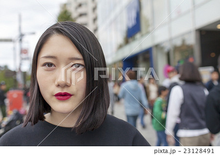 原宿 原宿駅前 ポートレート 女性 語る ファッション モード系 背景雑踏の写真素材