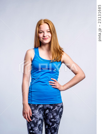 Girl in blue singlet and fitness leggings, young Girl in blue singlet and fitness leggings, young 23131685