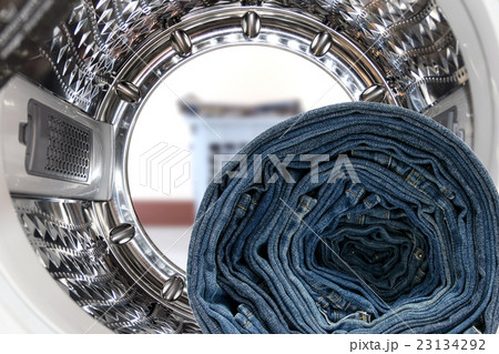 Blue jeans inside the washing machine. Blue jeans inside the washing machine. 23134292