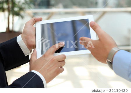 Image of two young businessmen using touchpad Image of two young businessmen using touchpad 23150429