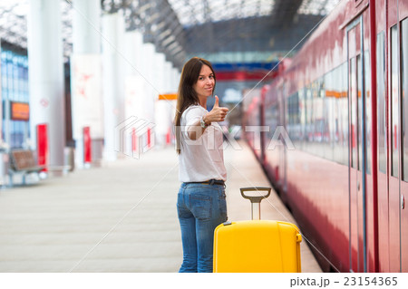 Young caucasian woman with luggage at station Young caucasian woman with luggage at station 23154365