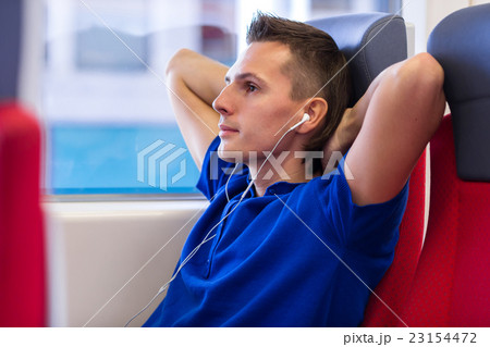 Young caucasian man listening music traveling by Young caucasian man listening music traveling by 23154472