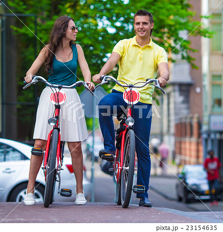Young happy caucasian couple on bikes in Amsterdam 23154635