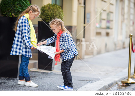 Adorable little girls with map of european city Adorable little girls with map of european city 23155436