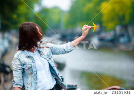 Woman with airplane model background of canal in 23155931