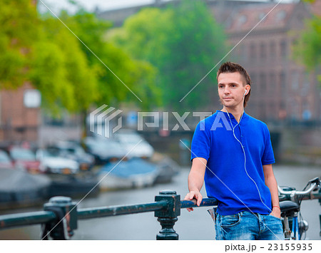 Young happy man listening to music background of Young happy man listening to music background of 23155935