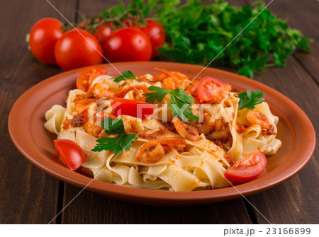 Fettuccine pasta with shrimp tomatoes and herbs. Fettuccine pasta with shrimp tomatoes and herbs. 23166899
