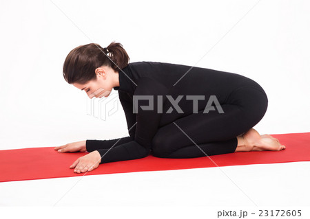 Beautiful athletic girl in black suit doing yoga 23172605