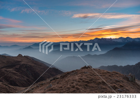 Mountain silhouette and stunning sky at sunset 23176333