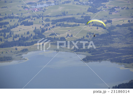 Paraglider flying over Bavarian lake 23186014
