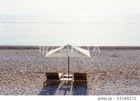 Sunbeds on sandy beach in sultry day, Montenegro 23188272