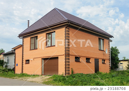 Two-storeyed orange brick house 23188708